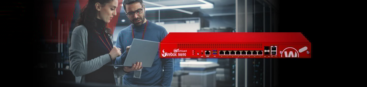 people in a server room working on a tablet with a red WatchGuard rackmount firewall in front