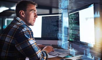 Image of security analyst focusing on computer screen