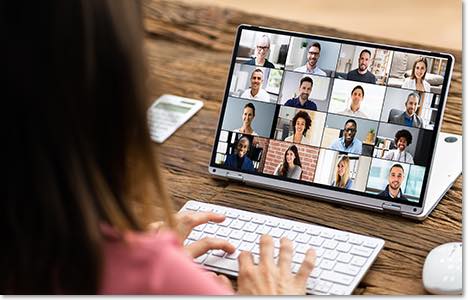 tablet computer showing a grid of faces in a video meeting call