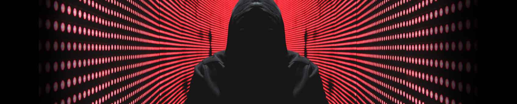 Dark shape in a black hoody in a room with red lights down the walls in stripes